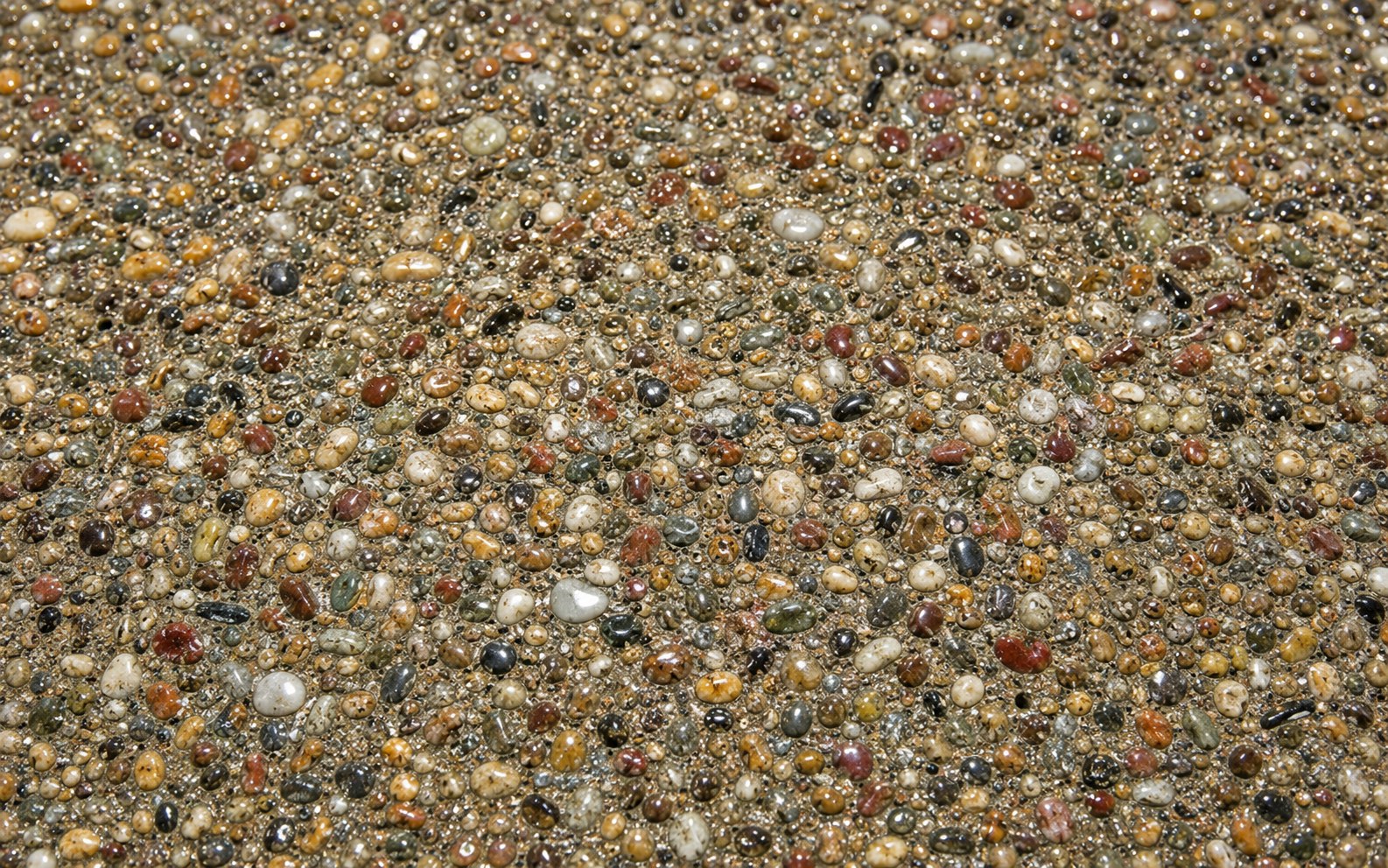 Exposed aggregate concrete surface with professional sealer Portland OR